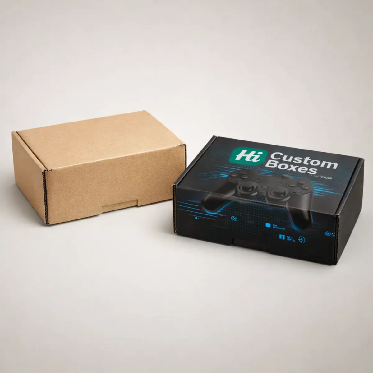 A brown kraft corrugated box next to a black custom-printed mailer box for gaming controllers. class=